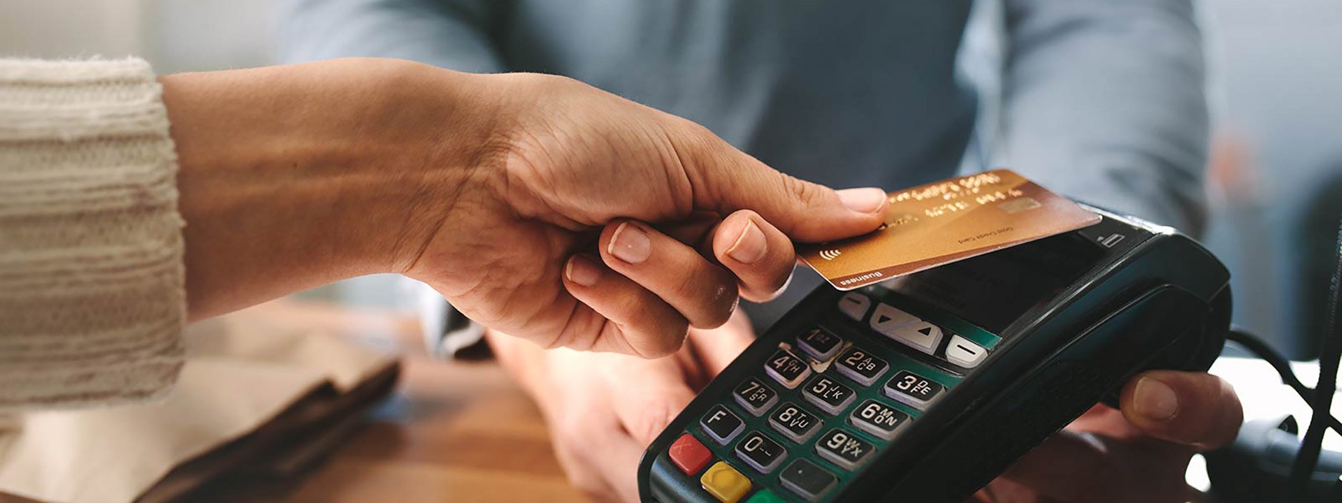 Pharmacist accepting credit card by contactless payment