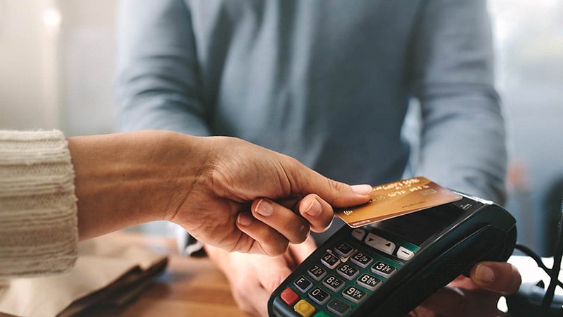 Pharmacist accepting credit card by contactless payment