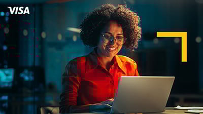 Woman working on a laptop late at night in an office