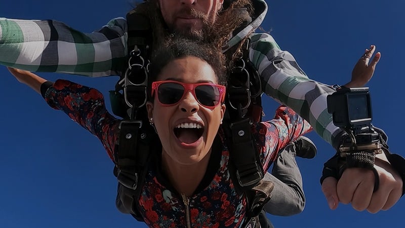 A man and a woman skydiving